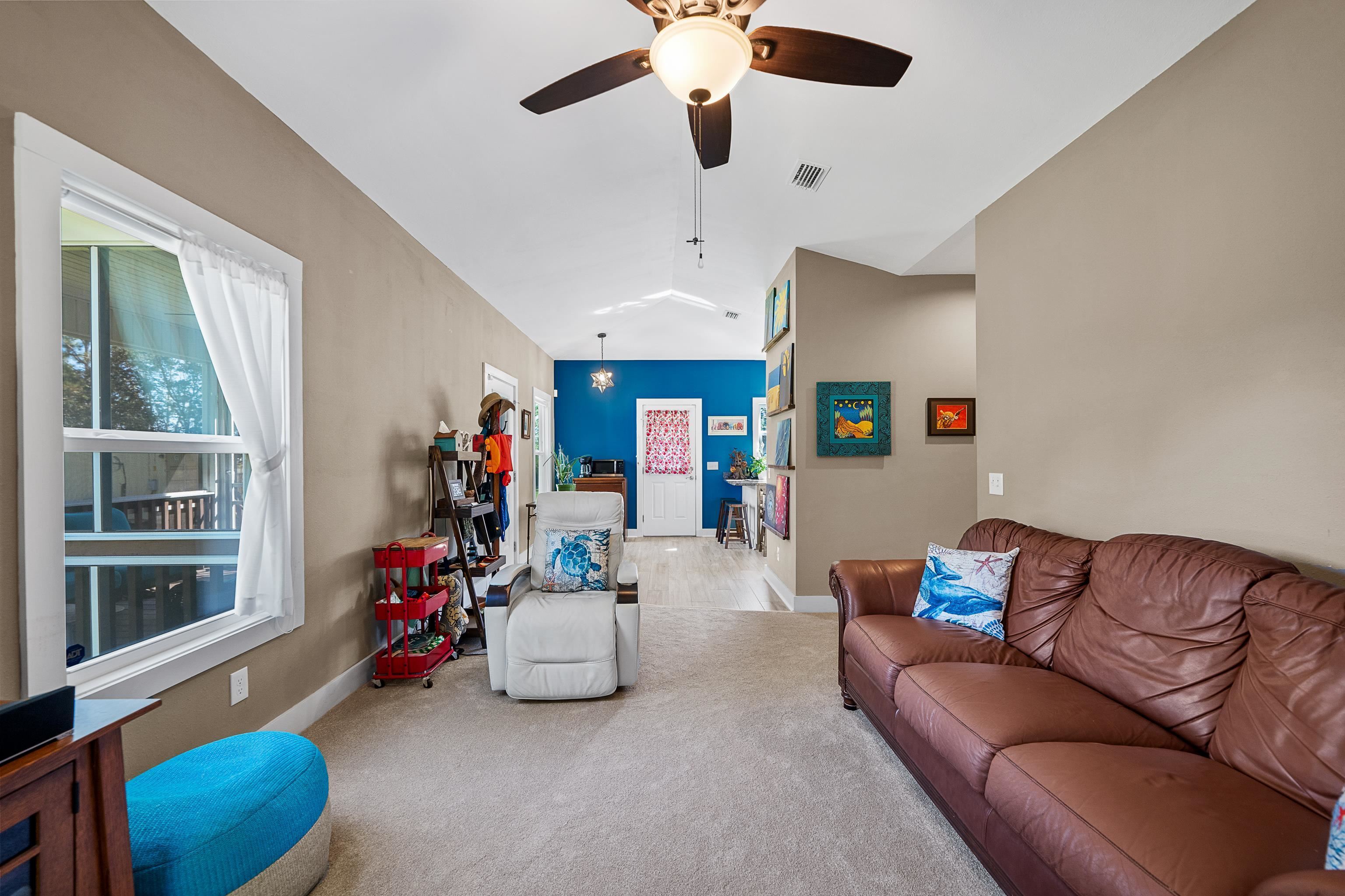 24616 Bretz Lane Elberta, AL 36530 - Photo 13 of 42 Living room with vaulted ceiling extending into dining area.