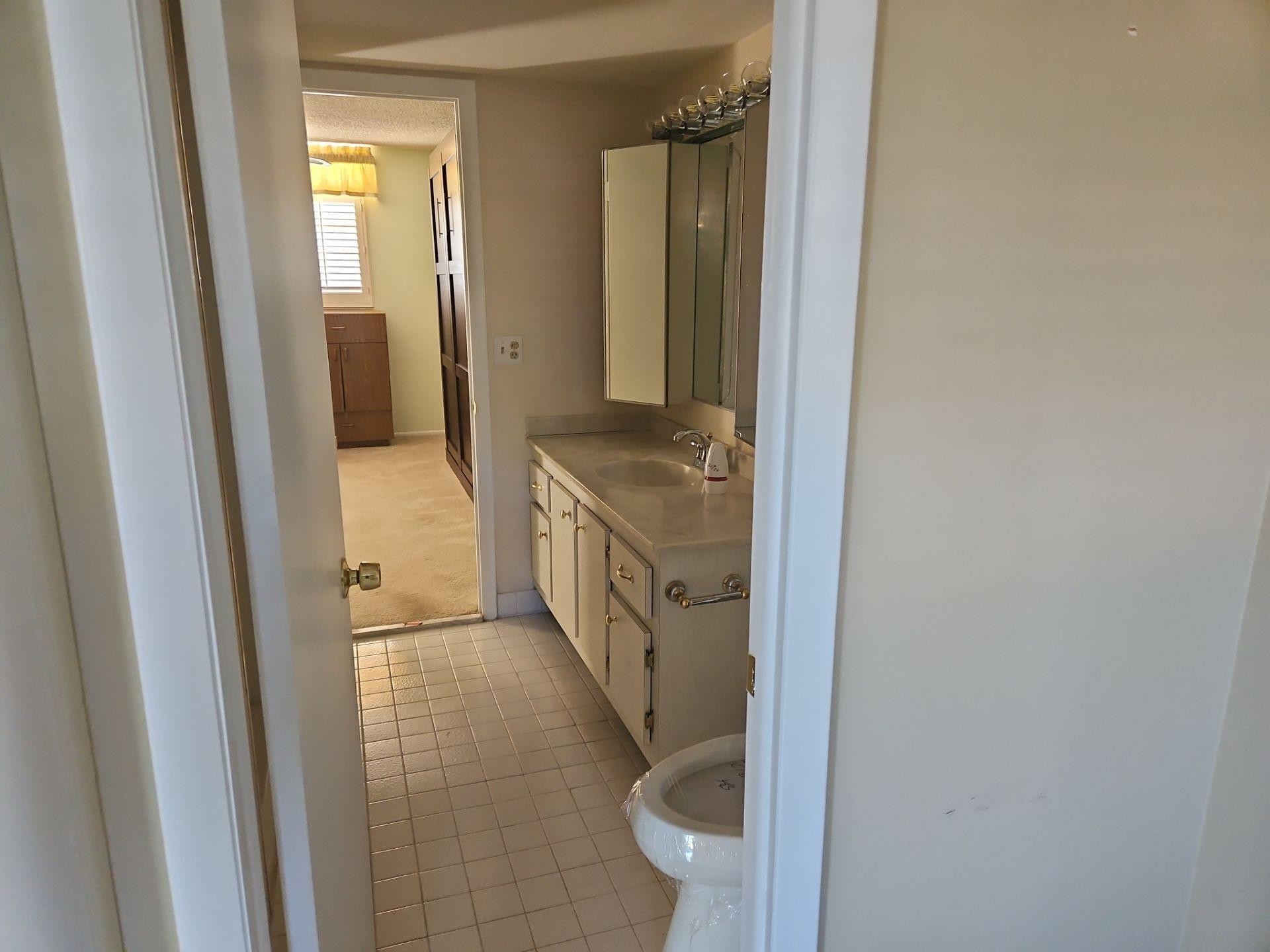 5201 Northwest 2nd Avenue, Unit 114 Boca Raton, FL 33487 - Photo 13 of 19 a bathroom with a granite countertop sink and a mirror