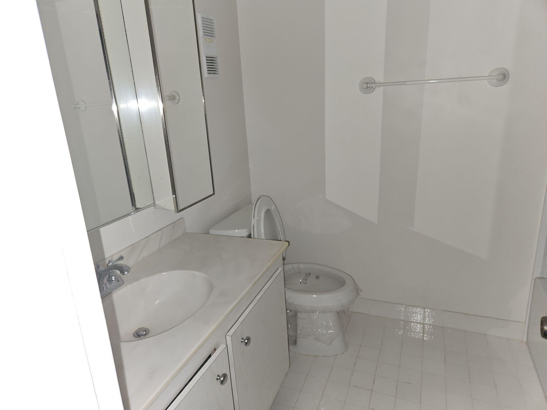5201 Northwest 2nd Avenue, Unit 114 Boca Raton, FL 33487 - Photo 17 of 19 a bathroom with a sink a toilet and shower