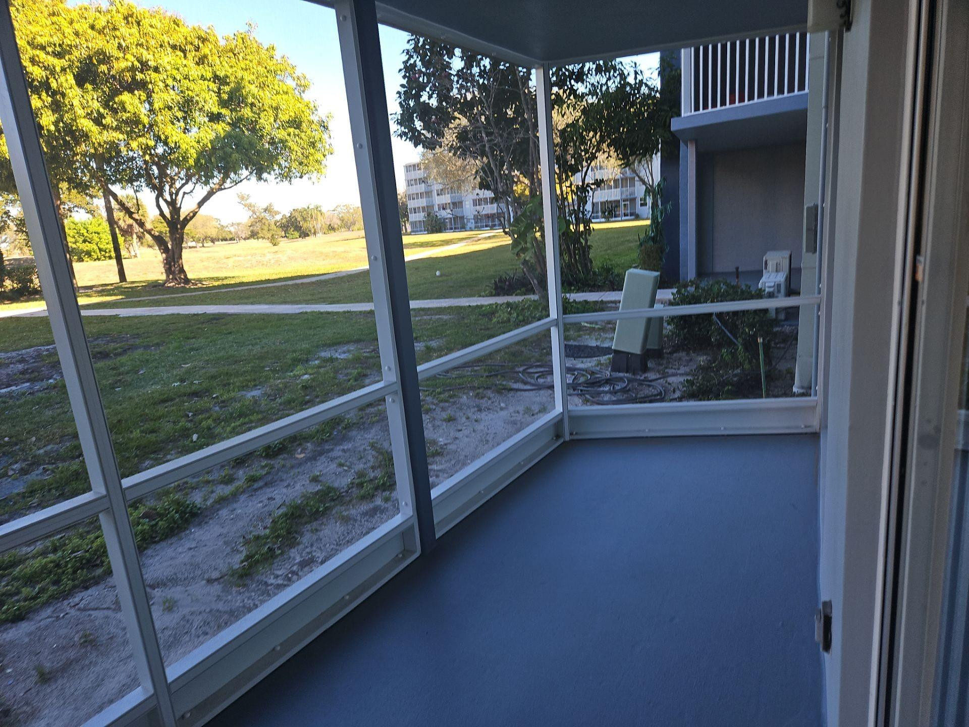 5201 Northwest 2nd Avenue, Unit 114 Boca Raton, FL 33487 - Photo 6 of 19 a view of a room with porch and wooden floor