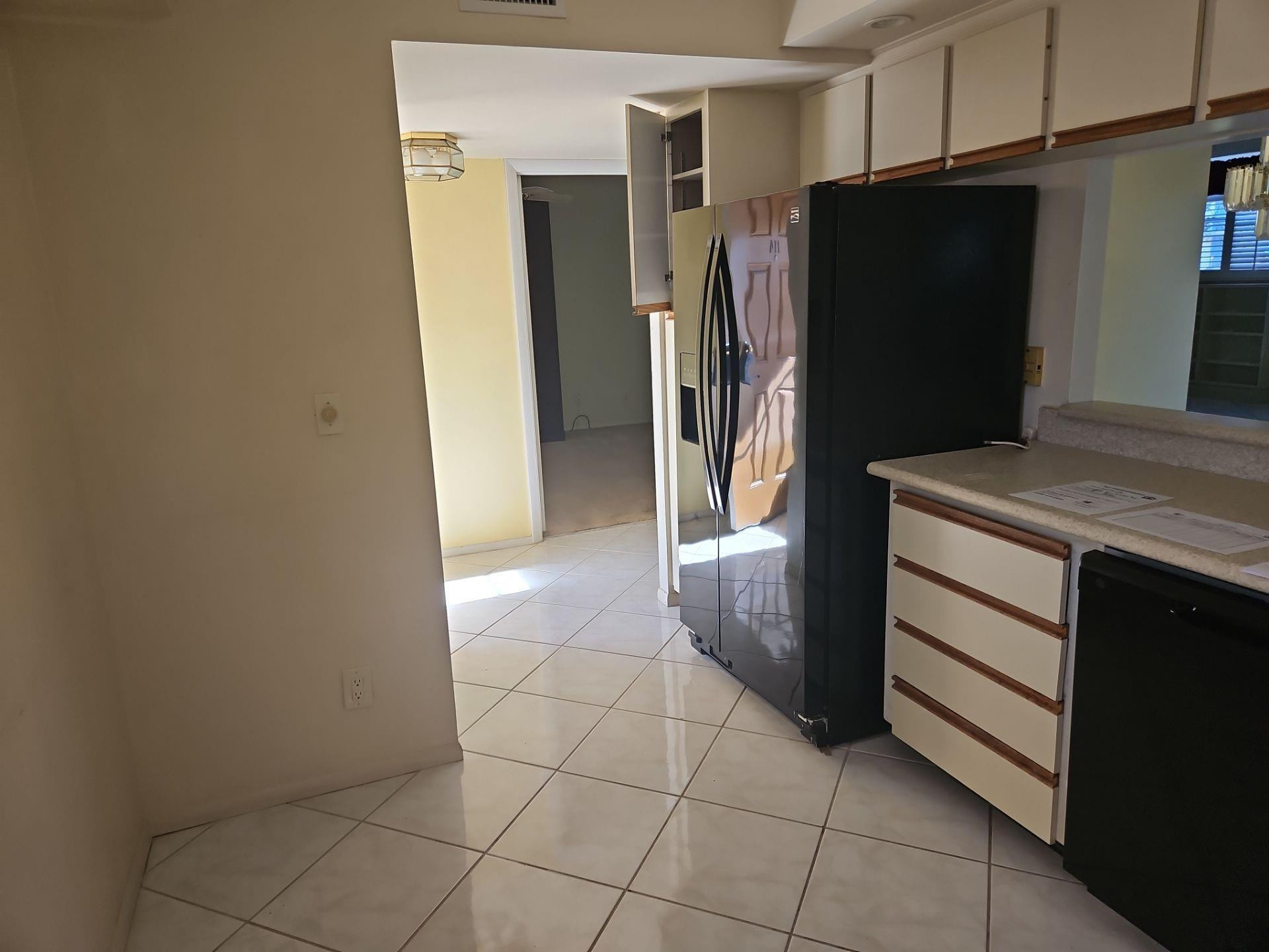 5201 Northwest 2nd Avenue, Unit 114 Boca Raton, FL 33487 - Photo 8 of 19 a kitchen with a refrigerator and microwave