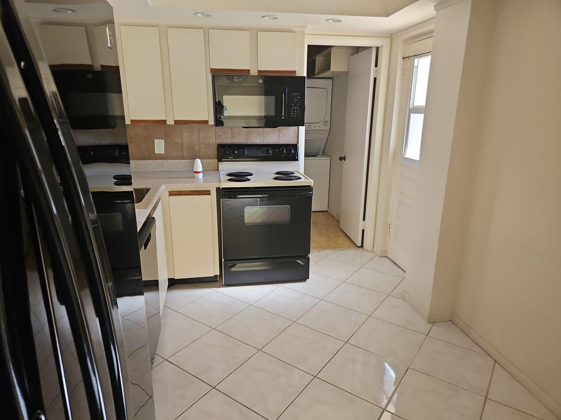 5201 Northwest 2nd Avenue, Unit 114 Boca Raton, FL 33487 - Photo 9 of 19 a kitchen with stainless steel appliances a refrigerator sink and microwave