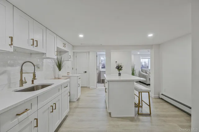 a kitchen with a sink cabinets and wooden floor