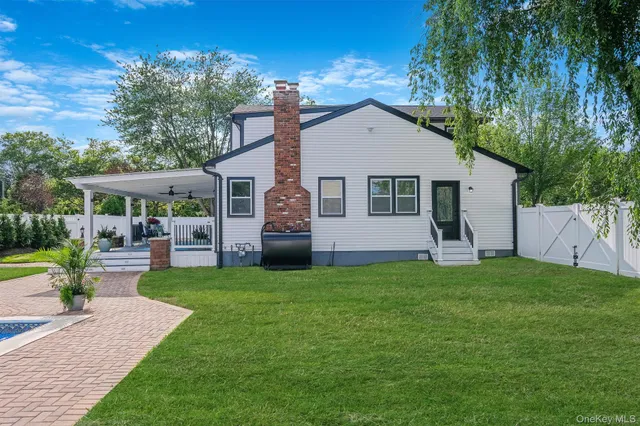 a view of a house with a yard and sitting area