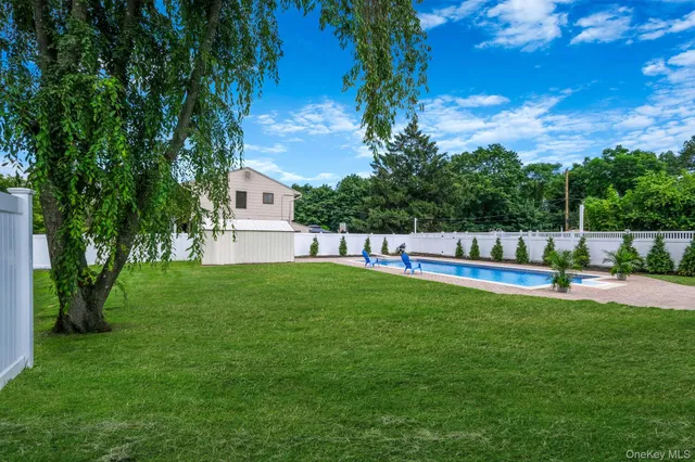 a view of a house with a yard and sitting area