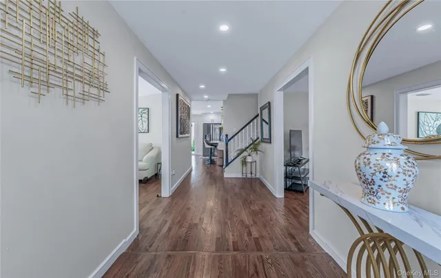 a view of entryway and hall with wooden floor