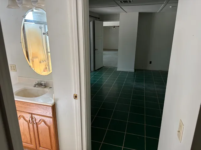 a bathroom with a glass door shower and a sink