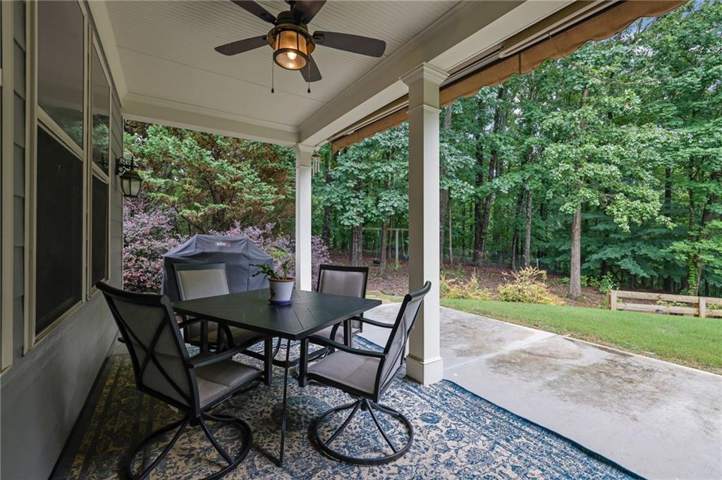 6255 Allison Road Cumming, GA 30040 - Photo 32 of 36 a view of a patio with a table chairs and a backyard