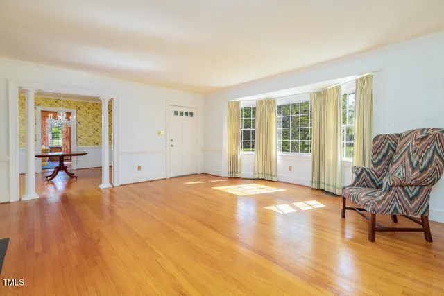 a bedroom with furniture and wooden floor
