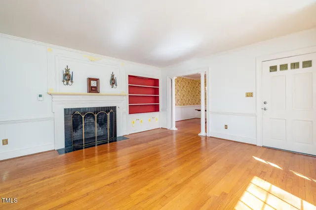 a spacious bedroom with a bed and wooden floor