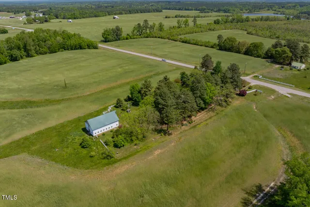 an aerial view of a house with yard and outdoor seating