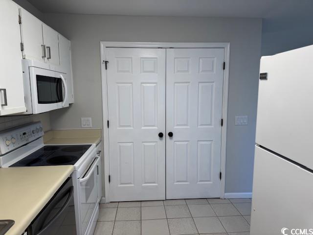 425 Myrtle Greens Drive, Unit B Conway, SC 29526 - Photo 13 of 18 Kitchen with white appliances, light countertops, white cabinetry, and light tile patterned floors