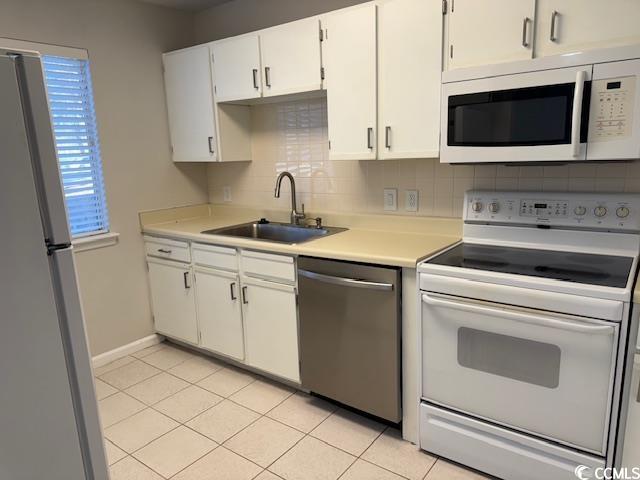 425 Myrtle Greens Drive, Unit B Conway, SC 29526 - Photo 14 of 18 Kitchen featuring white appliances, backsplash, light countertops, white cabinetry, and light tile patterned flooring