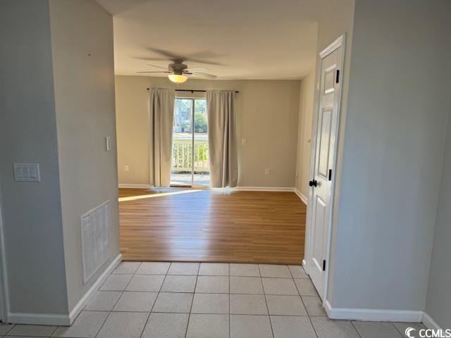 425 Myrtle Greens Drive, Unit B Conway, SC 29526 - Photo 10 of 18 Unfurnished room with light tile patterned floors and ceiling fan