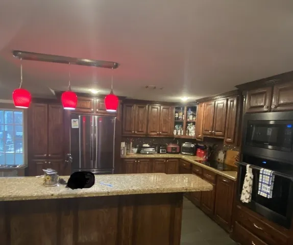 a living room with furniture and a pool table