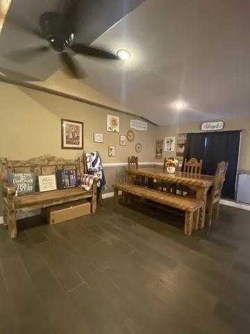 a living room with a couch and a dresser with wooden floor