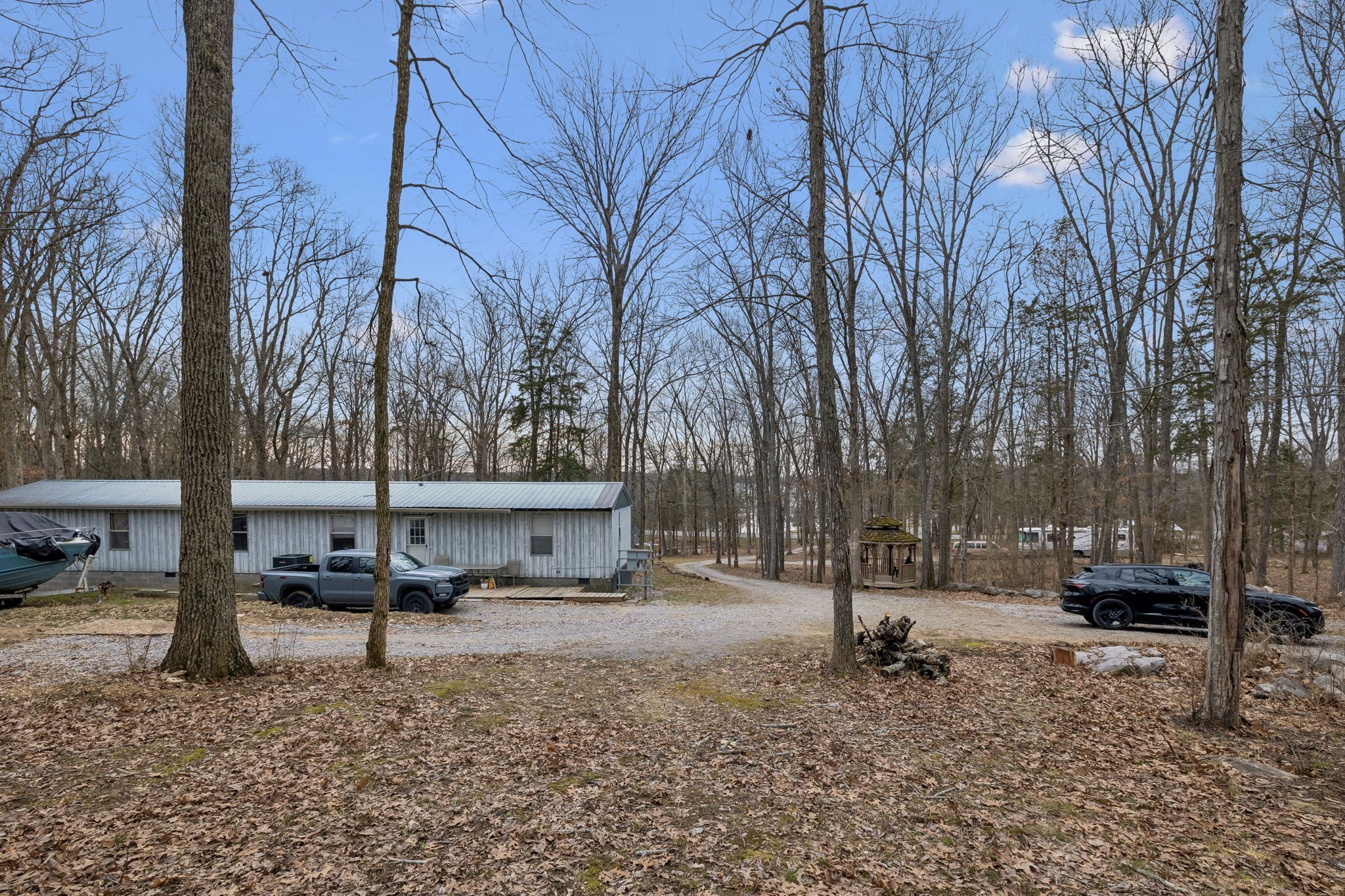 3726 Benders Ferry Road Mount Juliet, TN 37122 - Photo 7 of 25 a backyard of a house with parked cars