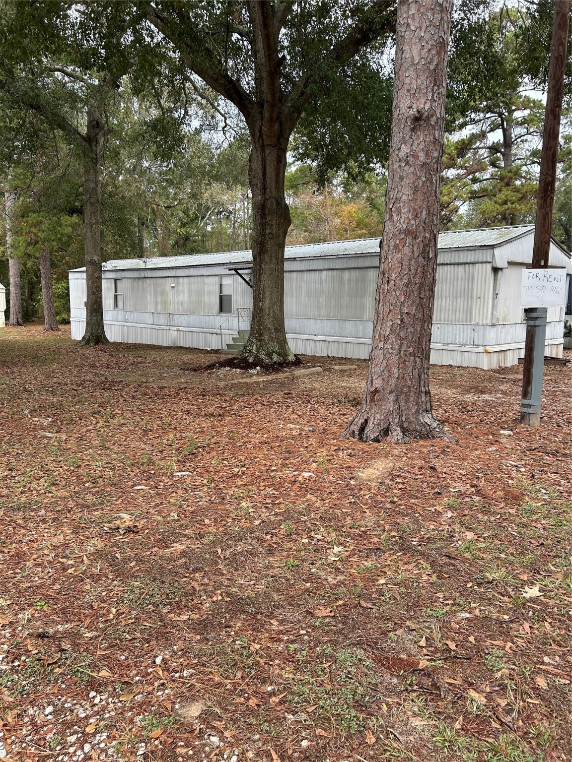 26163 Etta Road, Unit 7 Splendora, TX 77372 - Photo 3 of 10 a house with trees in front of it