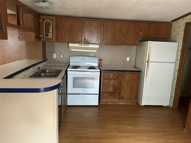 a kitchen with a refrigerator sink and stove
