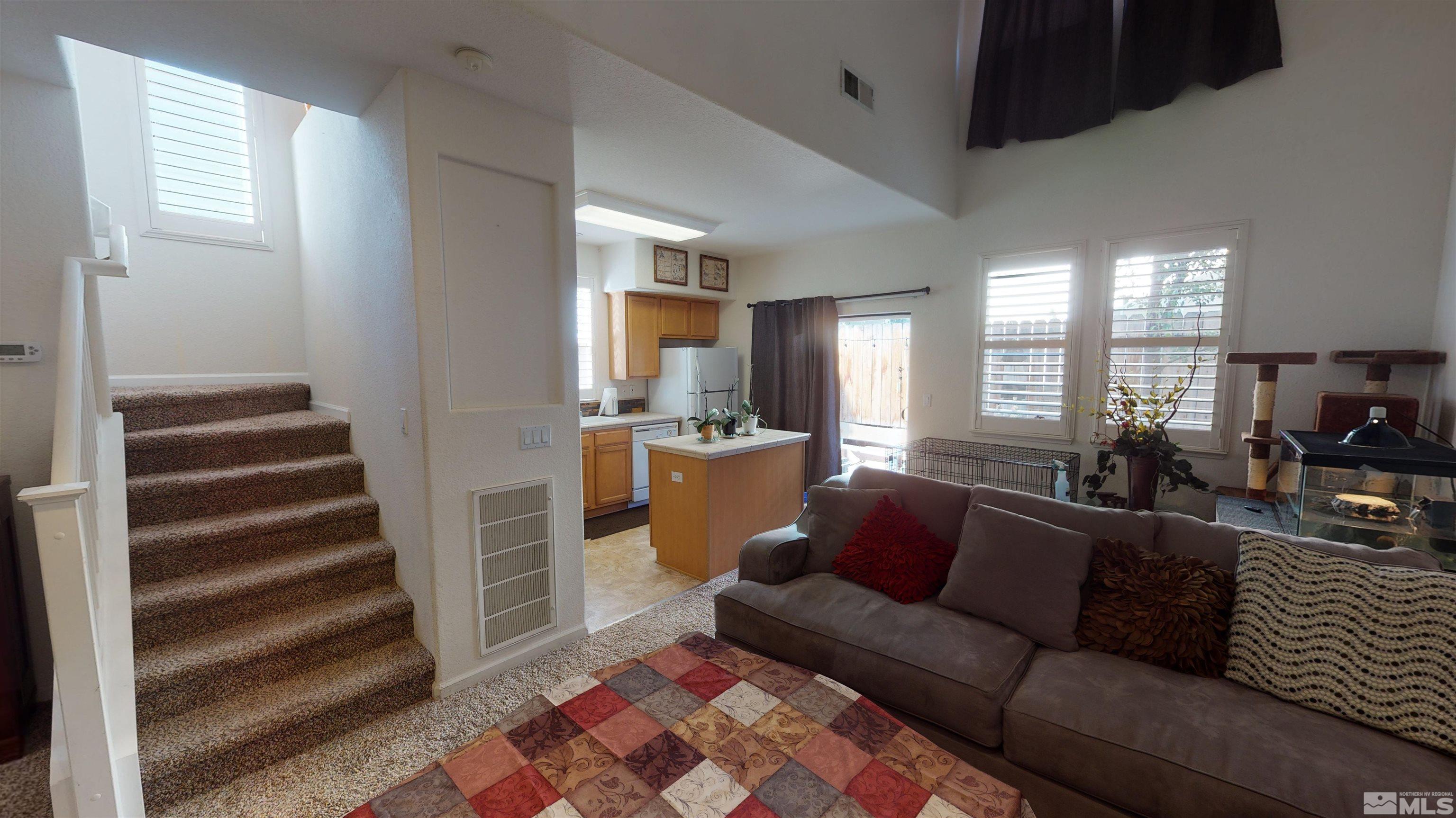 2175 Hellaby Lane Reno, NV 89502 - Photo 4 of 26 a view of a living room filled with furniture and a rug