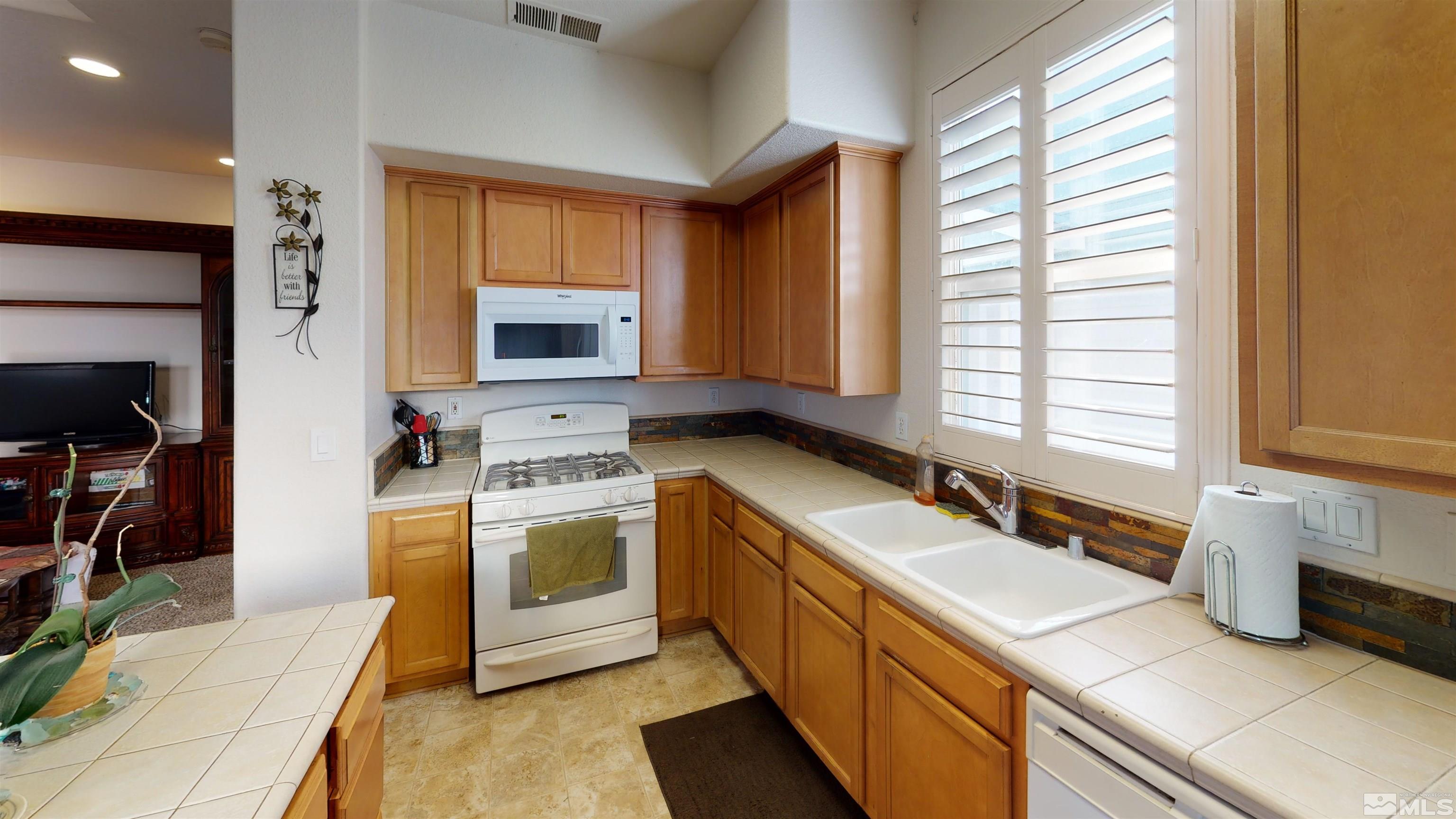 2175 Hellaby Lane Reno, NV 89502 - Photo 8 of 26 a kitchen with a sink stove and refrigerator