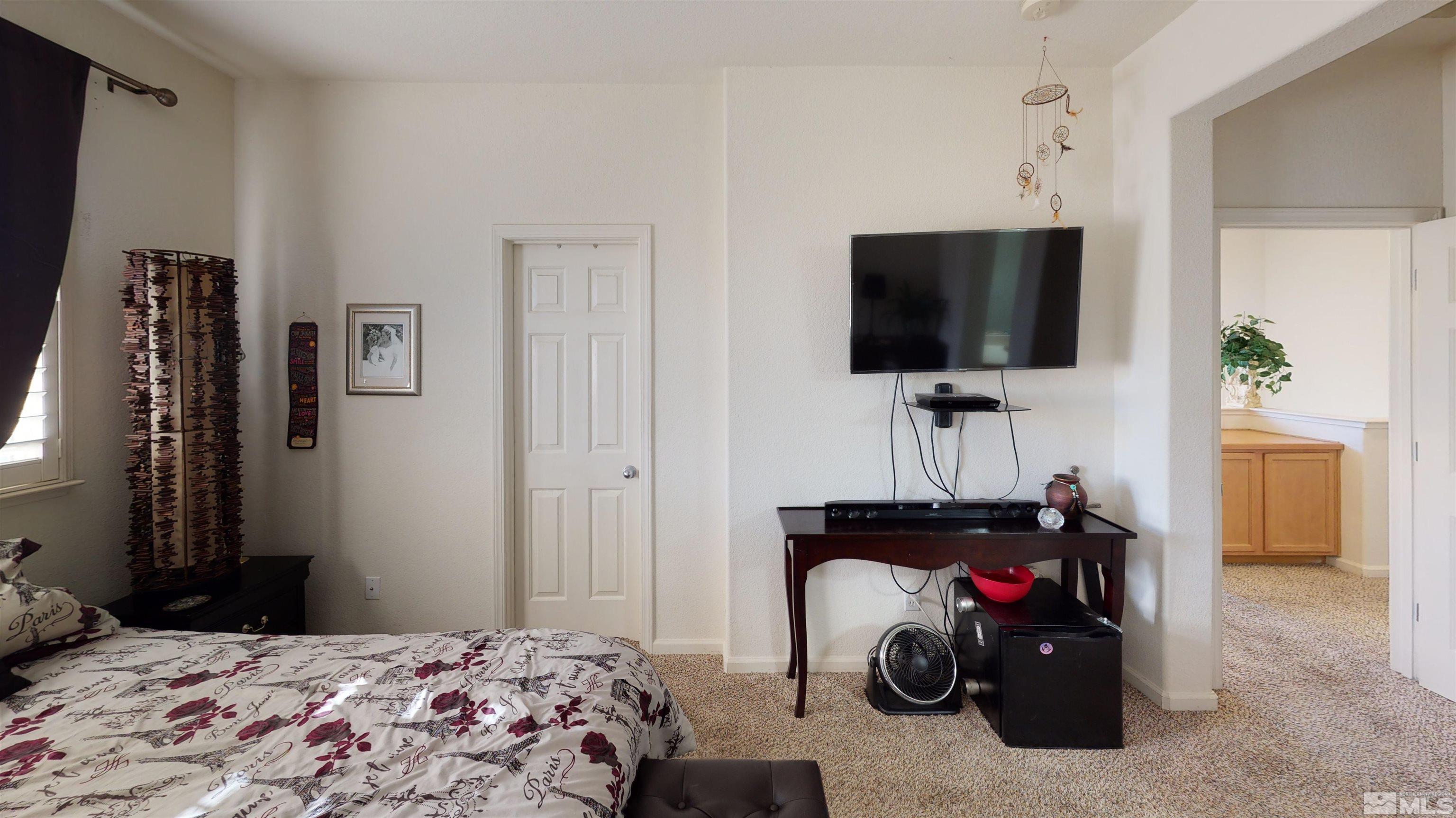 2175 Hellaby Lane Reno, NV 89502 - Photo 10 of 26 a bedroom with a bed and a flat screen tv