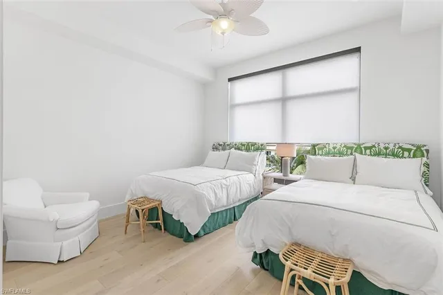 a bedroom with two beds and a chandelier