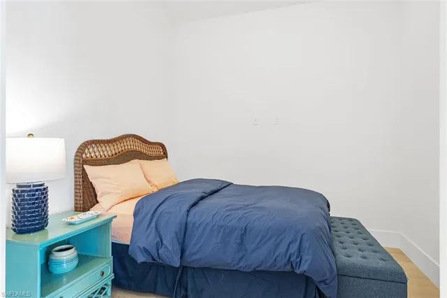 a bedroom with a bed and a wall painting