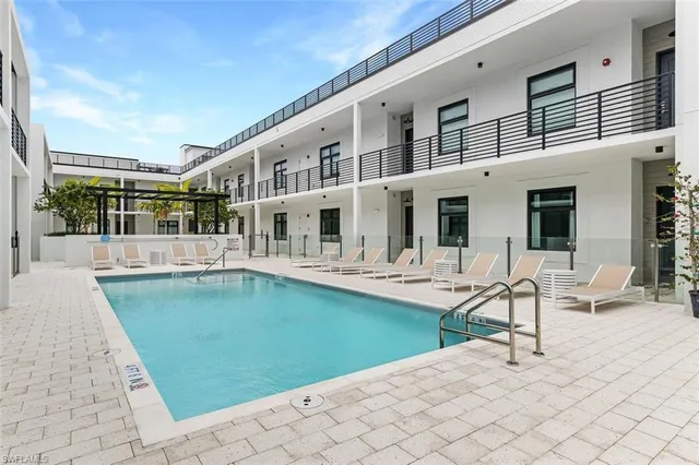 a swimming pool with outdoor seating