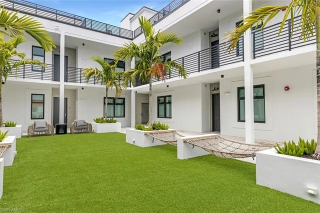 a front view of house with yard and outdoor seating
