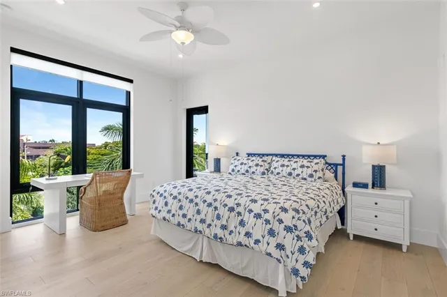 a bedroom with a large bed and a large window