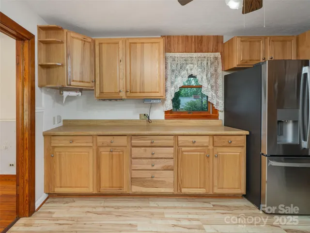 a kitchen with stainless steel appliances granite countertop a refrigerator and a stove top oven