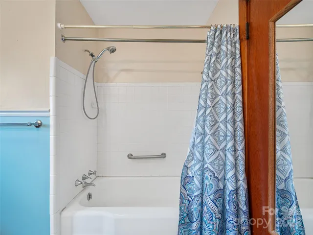 a bathroom with a shower curtain and a shower curtain