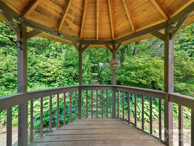 a view of a wooden deck next to a yard