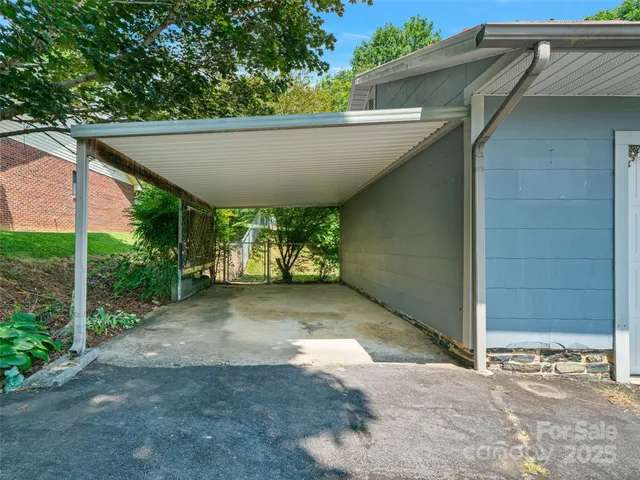 a view of a patio with table and chairs under an umbrella