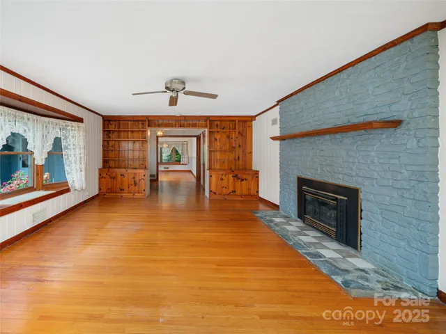 a view of livingroom with furniture fireplace and window