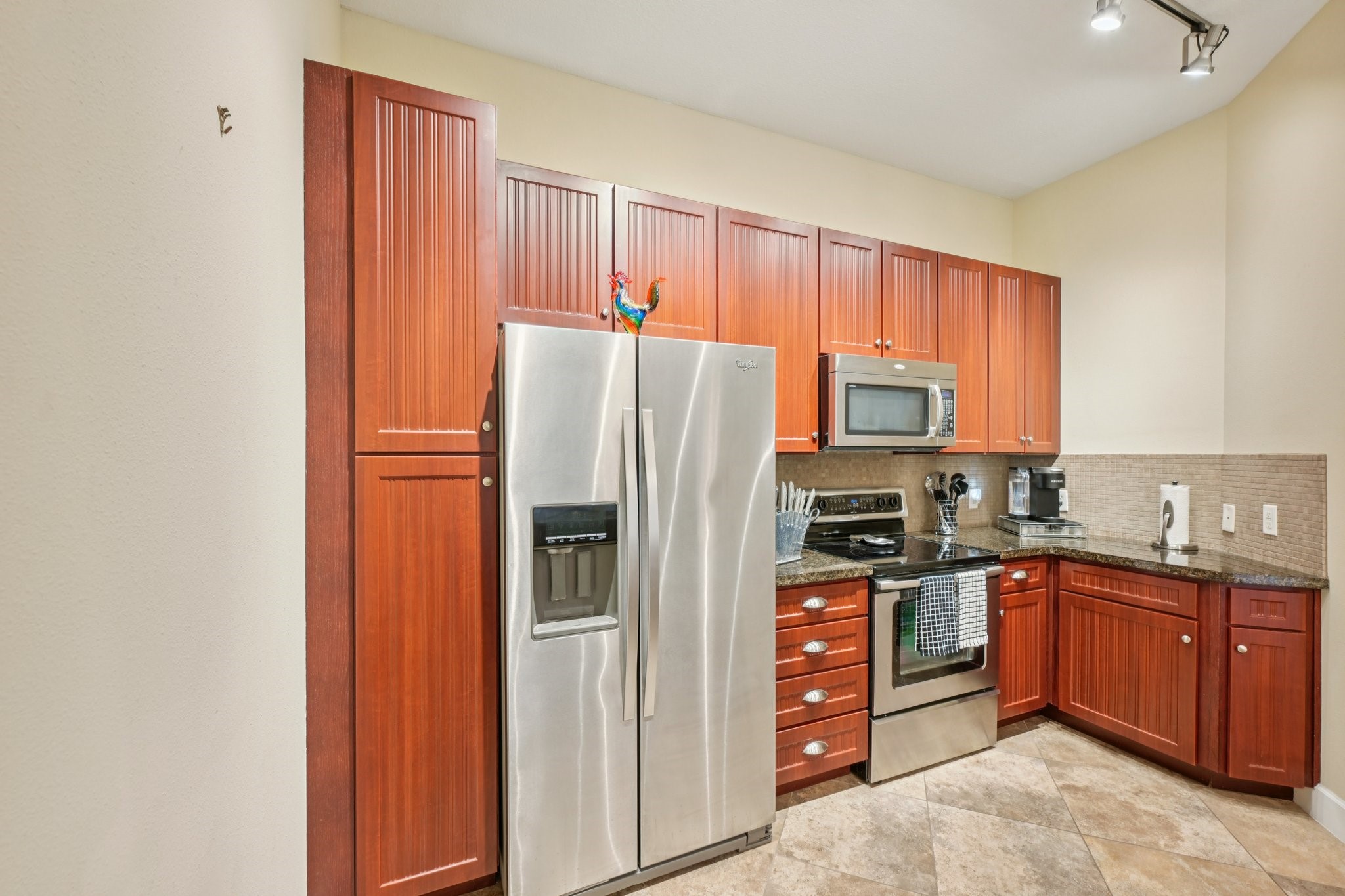 17040 West Fm 1097 Road, Unit 6103 Montgomery, TX 77356 - Photo 11 of 34 a kitchen with stainless steel appliances granite countertop a refrigerator and a stove top oven