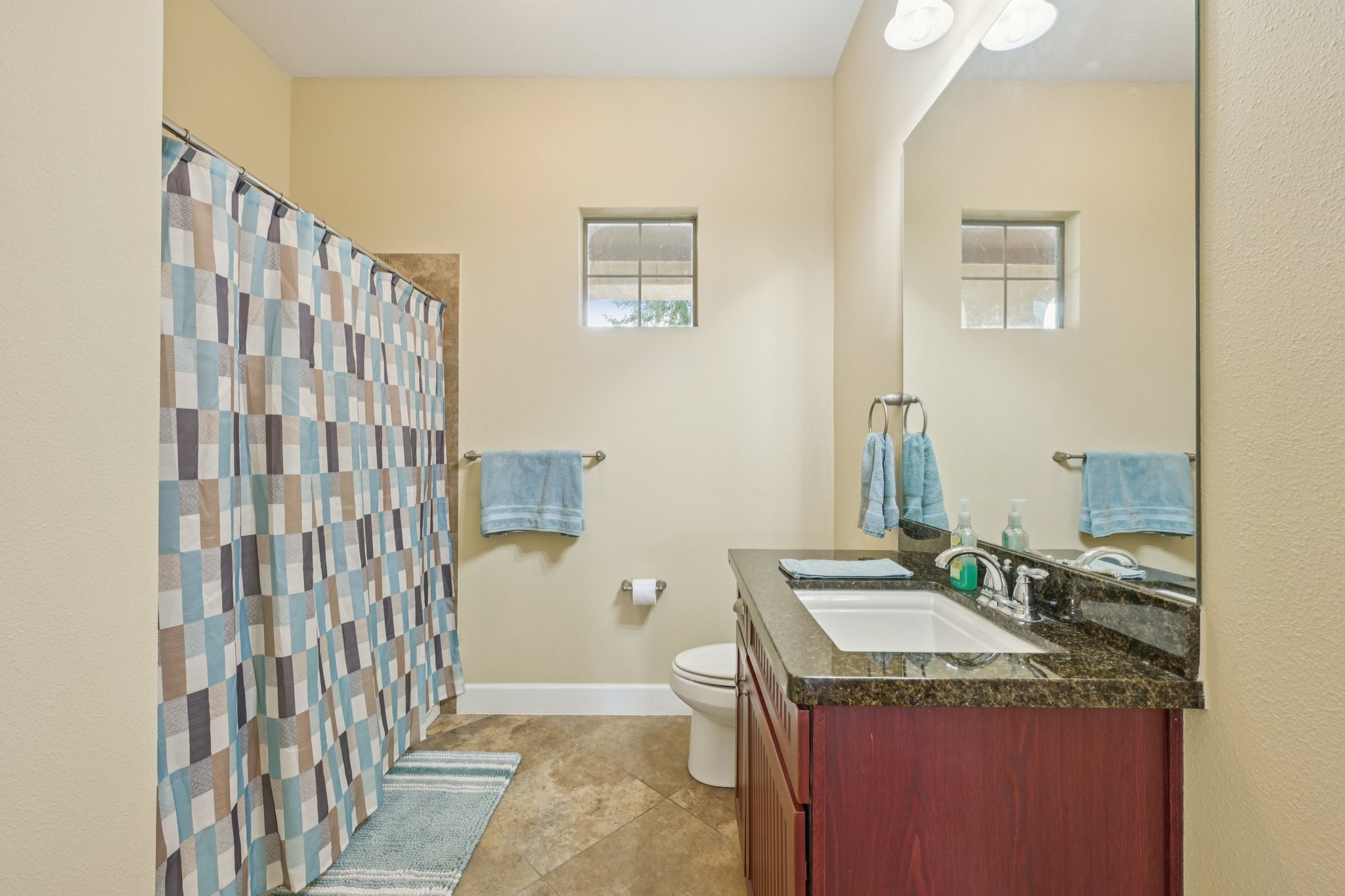 17040 West Fm 1097 Road, Unit 6103 Montgomery, TX 77356 - Photo 12 of 34 a bathroom with a granite countertop sink and a mirror