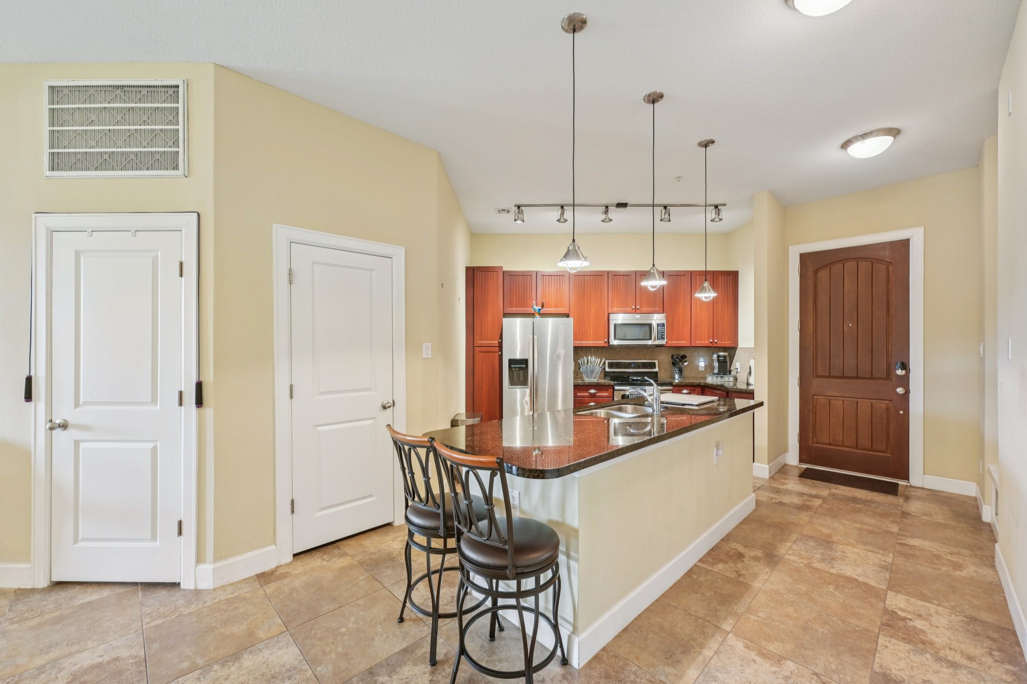 17040 West Fm 1097 Road, Unit 6103 Montgomery, TX 77356 - Photo 3 of 34 a kitchen with stainless steel appliances granite countertop a stove and a refrigerator