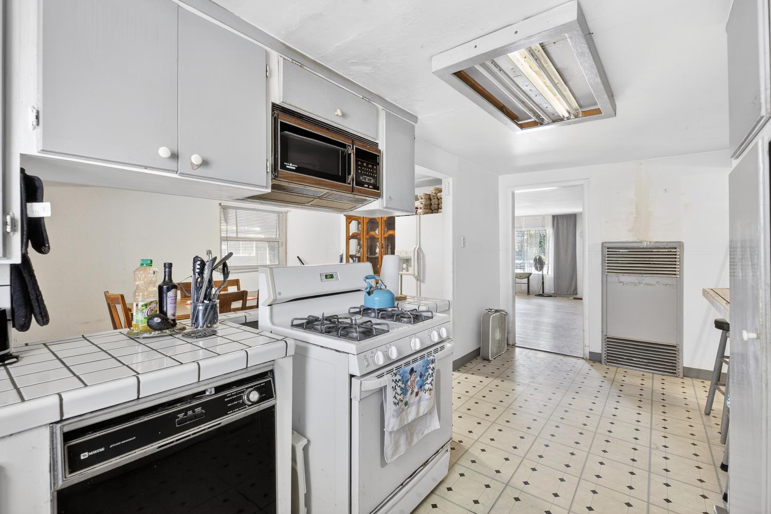 383 Taylor Road Lodi, CA 95242 - Photo 8 of 22 a kitchen with stainless steel appliances a stove a sink and a refrigerator