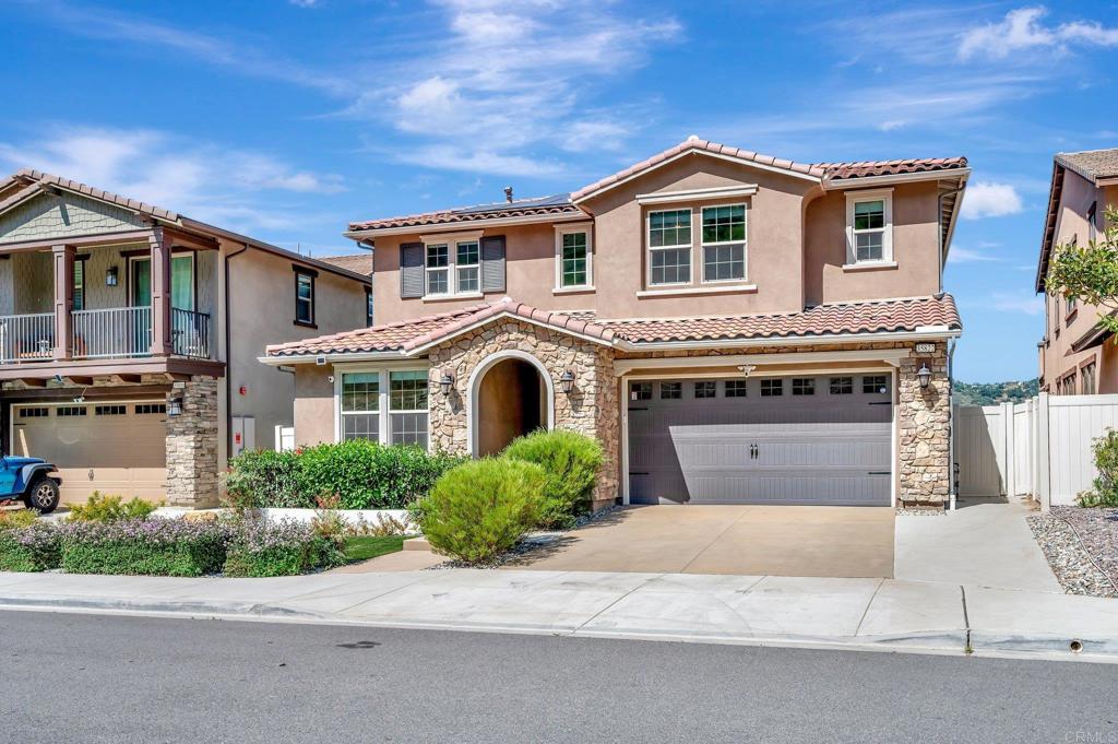 35822 Blue Breton Drive Fallbrook, CA 92028 - Photo 2 of 47 a front view of a house with a yard and garage