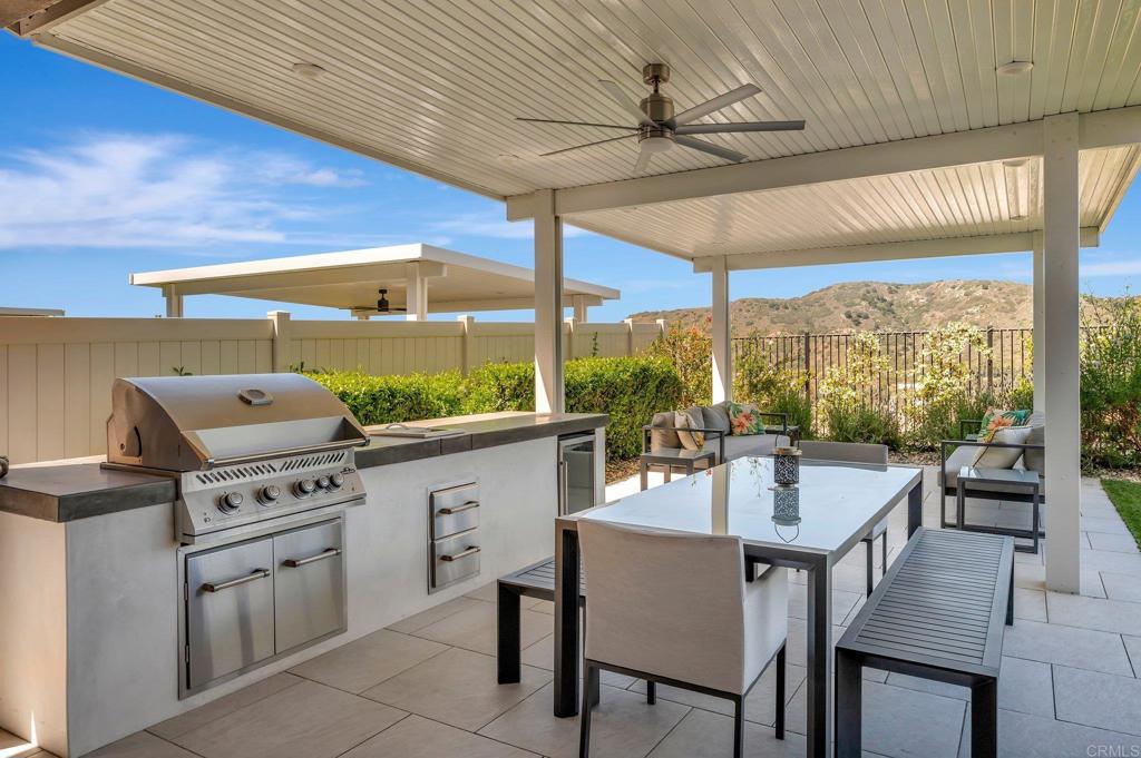 35822 Blue Breton Drive Fallbrook, CA 92028 - Photo 36 of 47 a kitchen with a table chairs stove and cabinets
