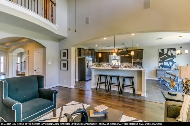 a living room with furniture and a kitchen view