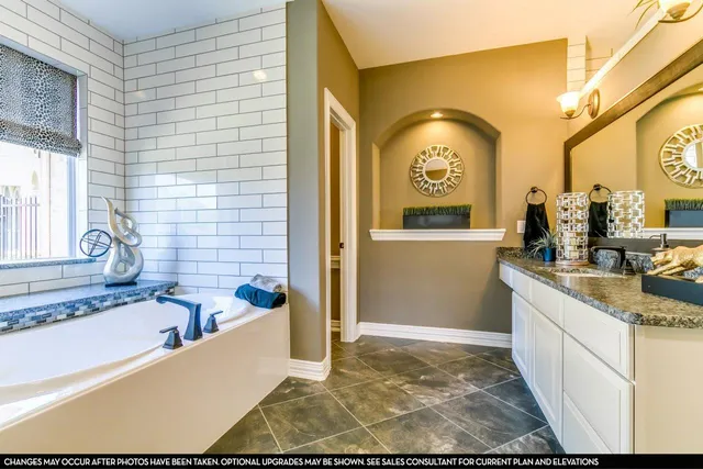 a bathroom with a tub sink and mirror