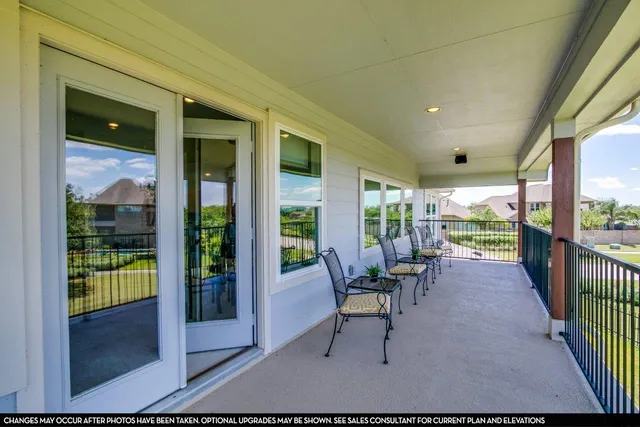 a view of a porch with chairs and backyard