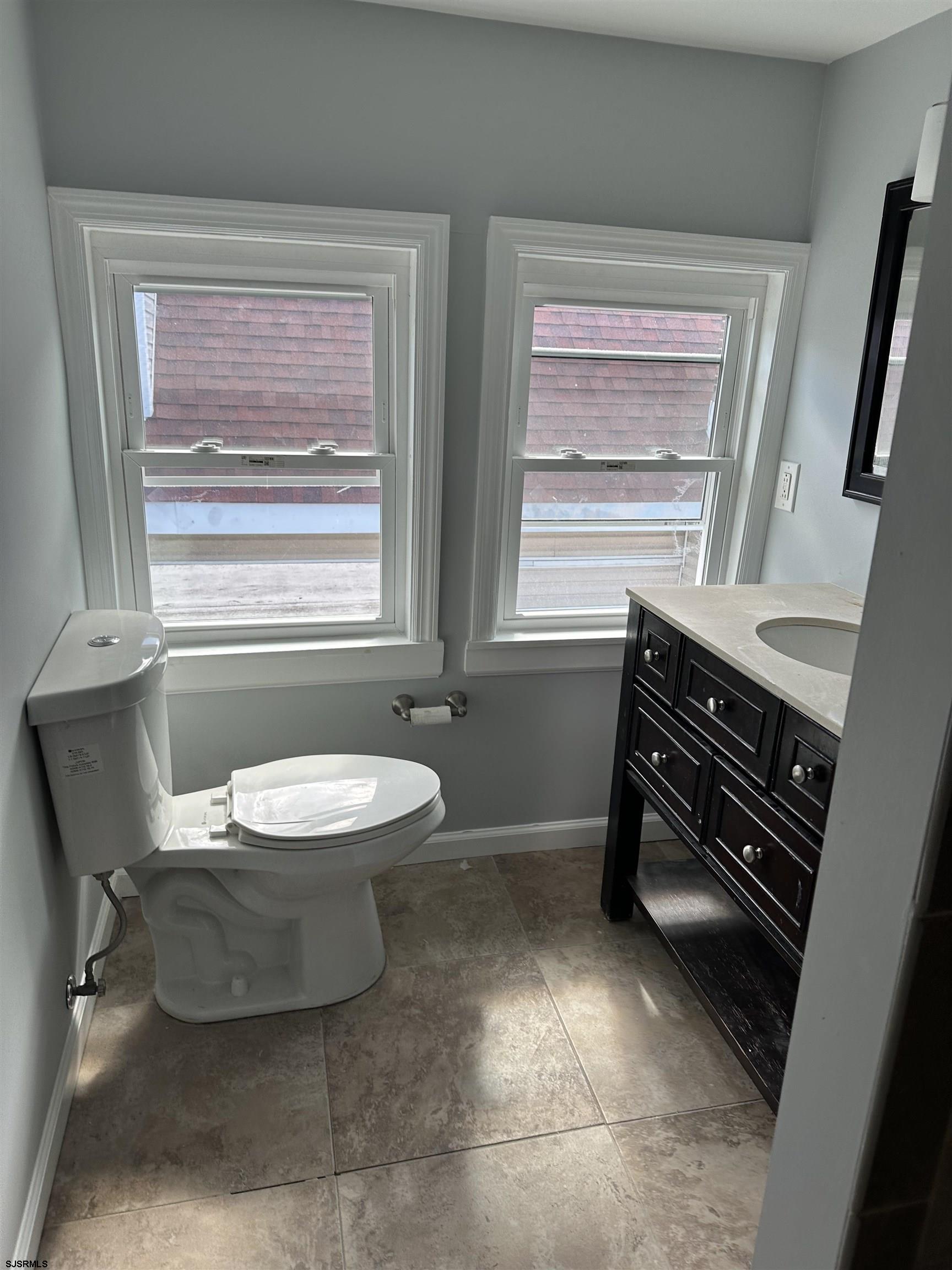 12 South Jackson Avenue, Unit SECOND Atlantic City, NJ 08401 - Photo 13 of 17 a bathroom with a sink toilet and window