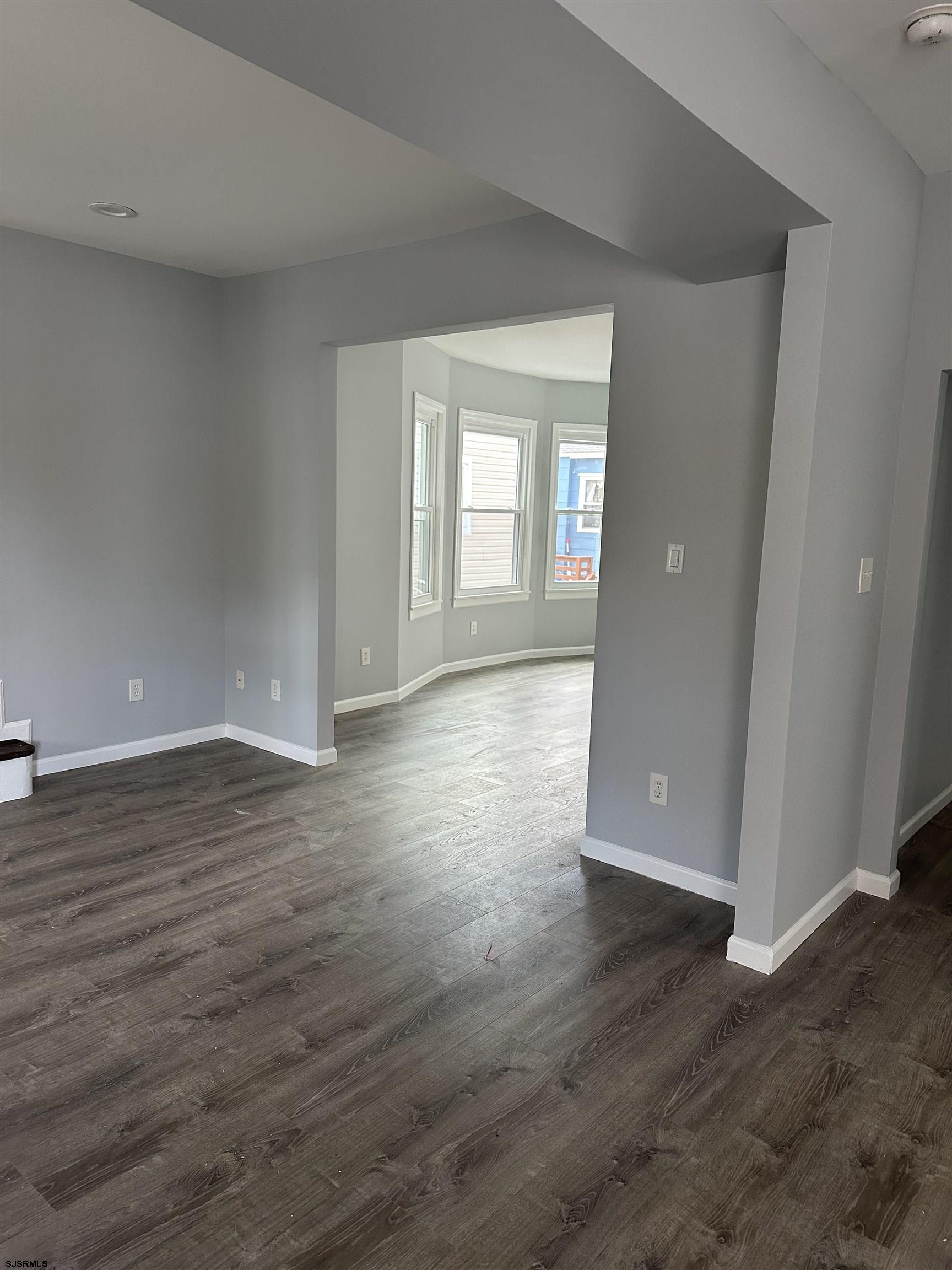 12 South Jackson Avenue, Unit SECOND Atlantic City, NJ 08401 - Photo 5 of 17 a view of wooden floor and windows in an empty room