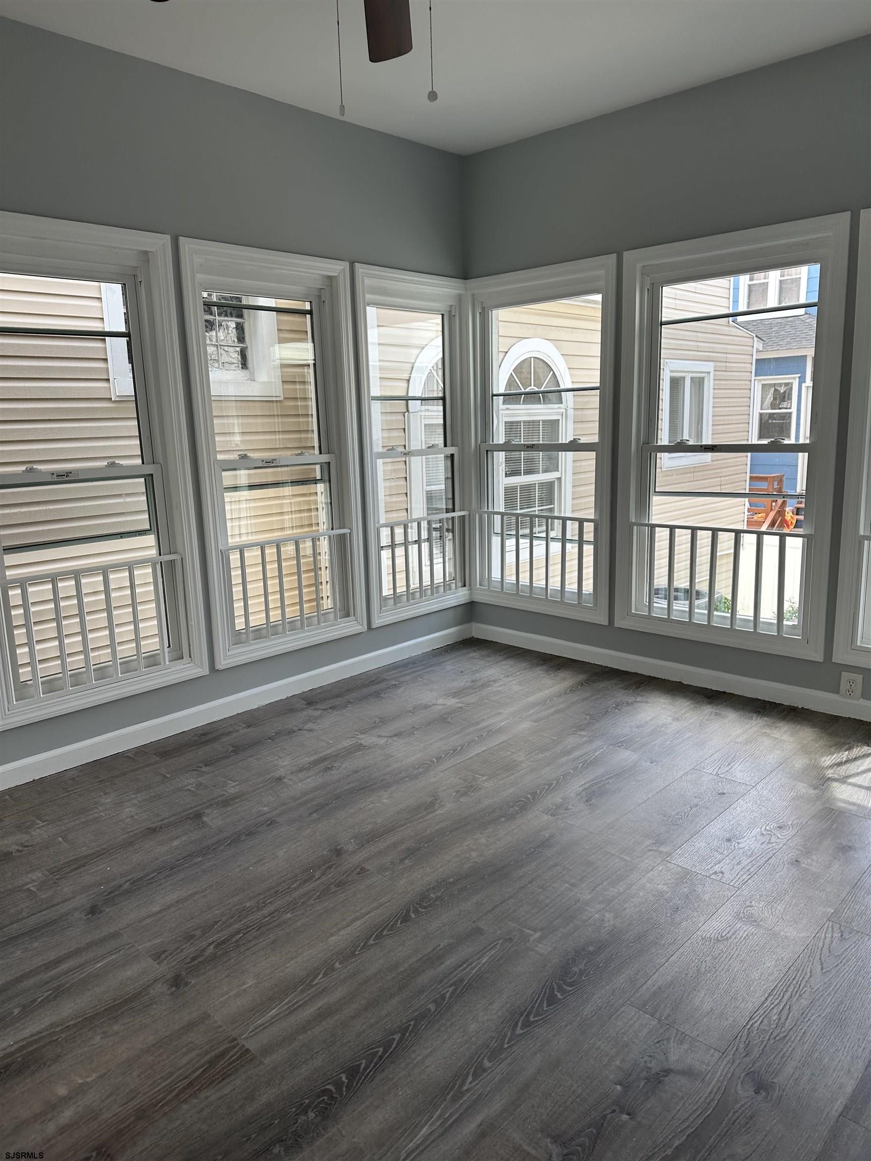 12 South Jackson Avenue, Unit SECOND Atlantic City, NJ 08401 - Photo 6 of 17 a view of an empty room with wooden floor and a window