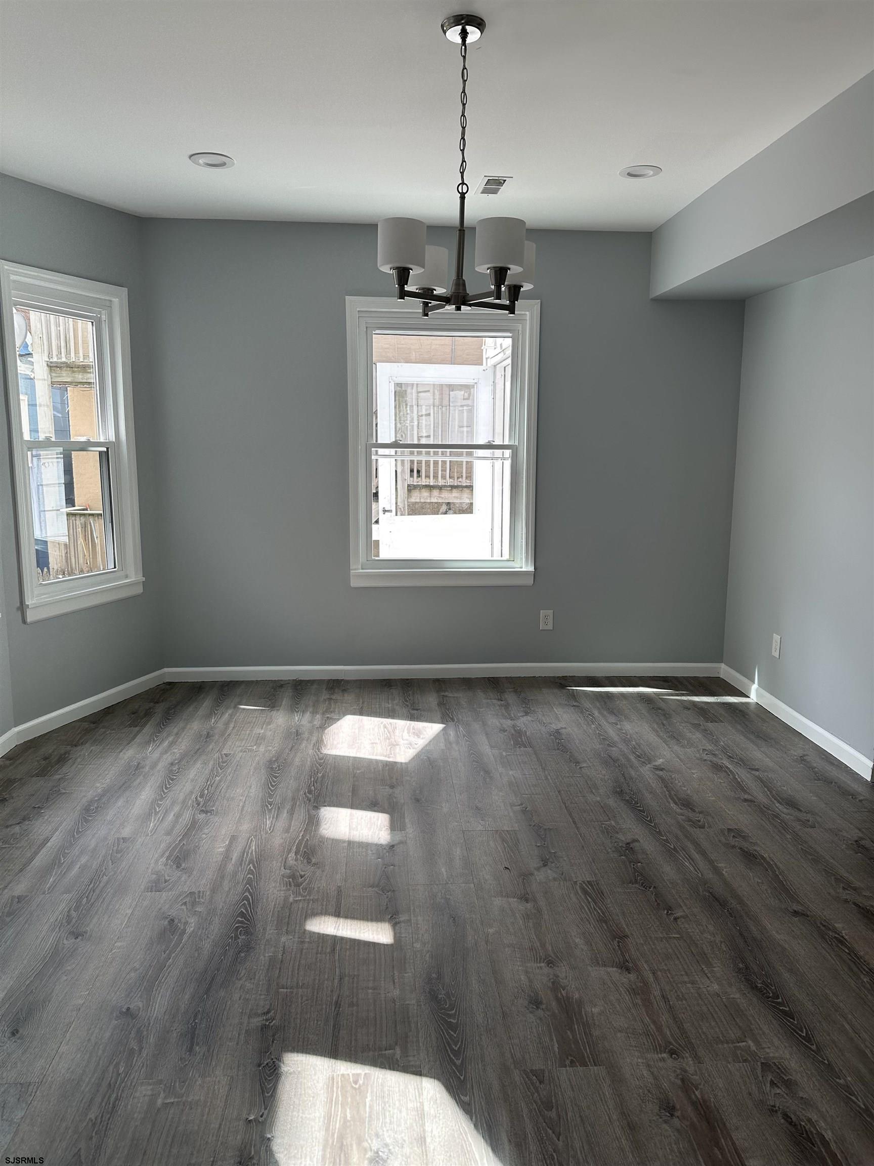 12 South Jackson Avenue, Unit SECOND Atlantic City, NJ 08401 - Photo 9 of 17 a view of an empty room with wooden floor and a window