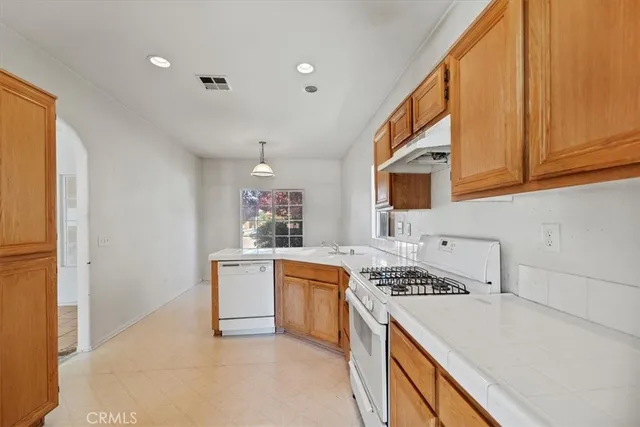a kitchen with stainless steel appliances granite countertop a stove and a sink